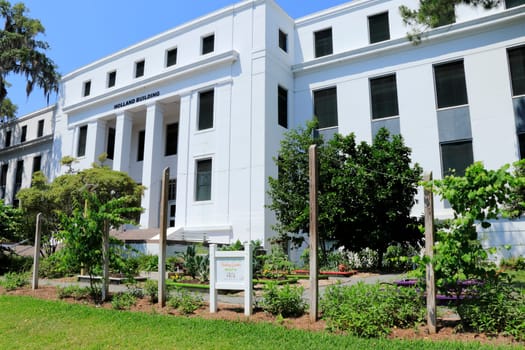 Tallahassee, FL, USA - May 13, 2018: Holland Building with teaching garden signs. Teaching Gardens in front of the Holland Building downtown. Florida Kids Teaching Garden at the Holland Building front