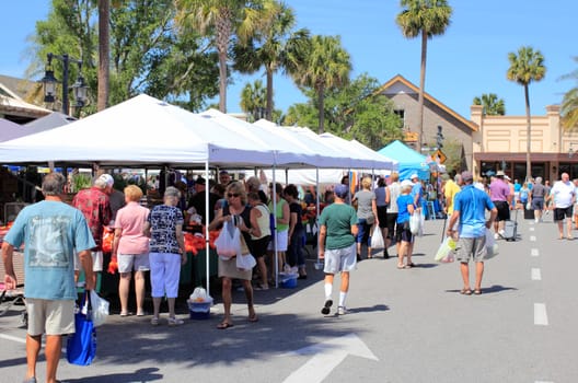 The Villages, FL, USA -April 1, 2017: People shop from various market sellers. People buy at Farmer’s Market shops near Paddock Square. Shoppers enjoy one of the Farmer’s Market in The Villages
