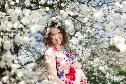 Spring, Young beautiful pregnant woman in the Orchard