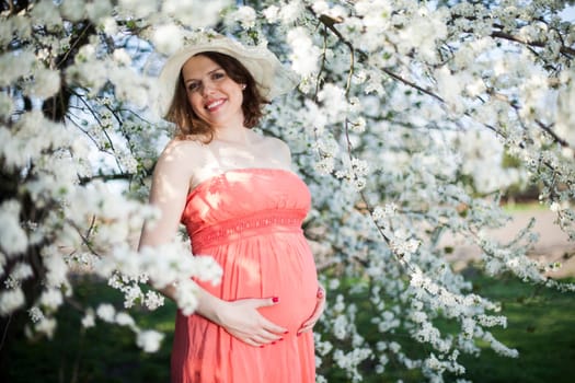 Spring, Young beautiful pregnant woman in the Orchard