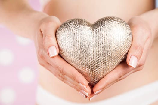 Pregnant woman holding a heart