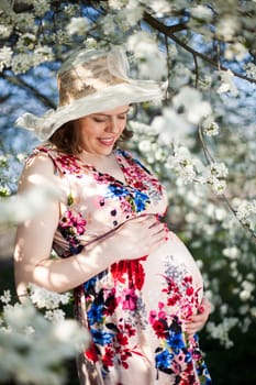 Spring, Young beautiful pregnant woman in the Orchard