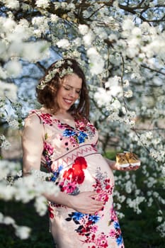 Spring, Young beautiful pregnant woman in the Orchard