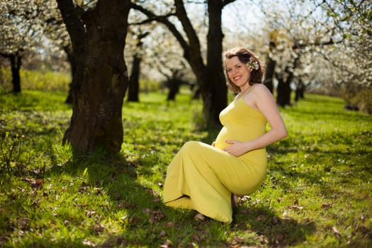 Blooming garden, Beautiful pregnant woman