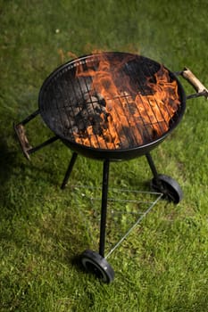 Barbecue grill with fire on nature, outdoor, close up