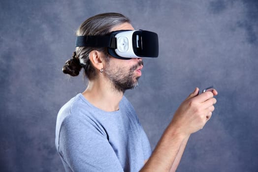 young man with virtual reality glasses playing game