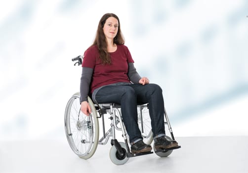 young woman in wheelchair in front of bright  background