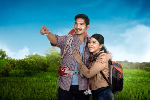 Smiling asian couple traveling and enjoying the scenery at nature