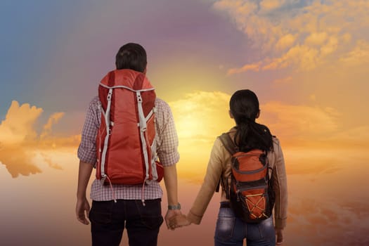 Young asian couple enjoying scenery together with dramatic sky background