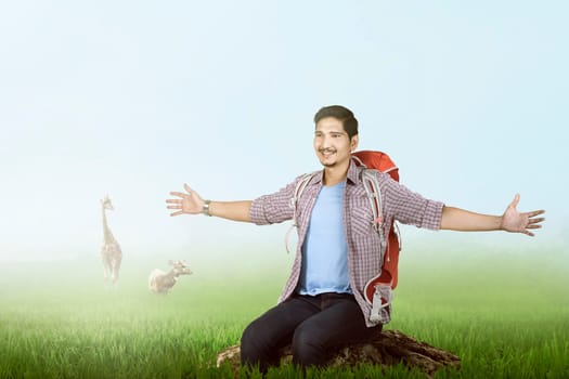 Happy asian traveler enjoying the scene with green grass background