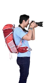 Portrait of asian photographer man taking a photos with camera posing isolated over white background