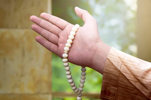 Muslim man holding prayer beads on his hand