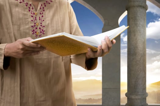 Muslim man reading the Koran inside the mosque