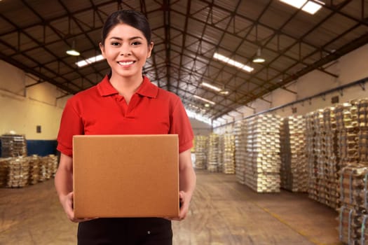 Beautiful asian delivery woman carrying boxes in the distribution warehouse