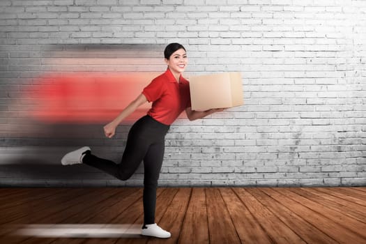 Happy asian courier woman delivering the package with wall background
