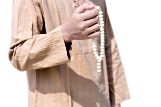 Muslim man holding prayer beads isolated over white background