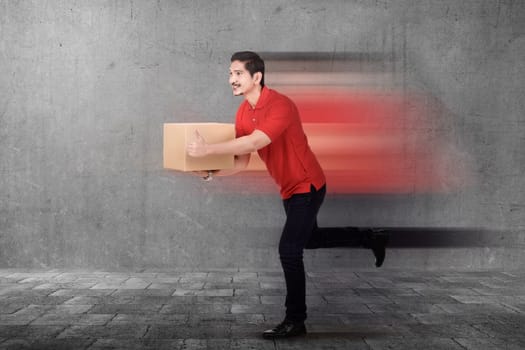 Handsome asian courier man delivering package on the urban street