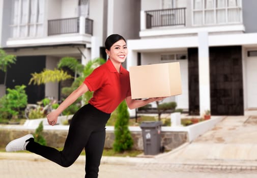 Young asian delivery woman delivering package to destination home