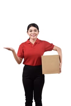 Pretty asian delivery woman holding package and showing something isolated over white background