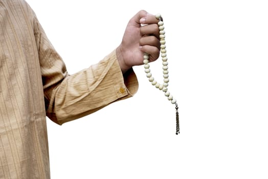 Muslim man holding prayer beads isolated over white background