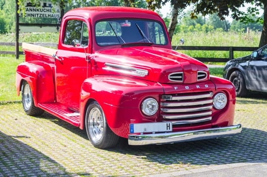 Mülheim Ruhr, Nrw, Germany - June 04, 2015:.An old renovated red Ford vintage pickup in a parking lot.