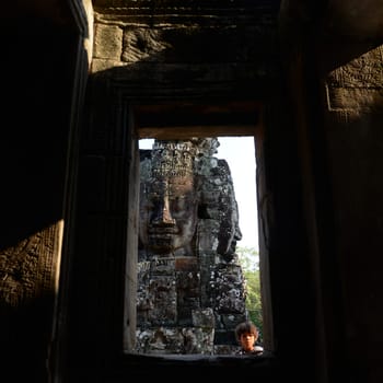 Stone face at the Bayon Temple the Tempel Ruins of Angkor Thom in the Temple City of Angkor near the City of Siem Reap in the west of Cambodia.  Cambodia, Siem Reap, April 2014