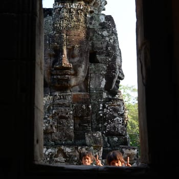 Stone face at the Bayon Temple the Tempel Ruins of Angkor Thom in the Temple City of Angkor near the City of Siem Reap in the west of Cambodia.  Cambodia, Siem Reap, April 2014