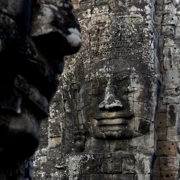 Stone Faces at the Bayon Temple the Tempel Ruins of Angkor Thom in the Temple City of Angkor near the City of Siem Reap in the west of Cambodia.  Cambodia, Siem Reap, April 2014
