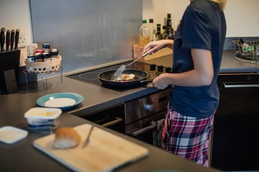 High angle view of an unrecognisable person making an egg sandwich for breakfast.