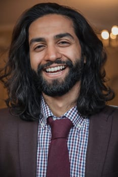 Front view of a young businessman giving a smile for the camera.