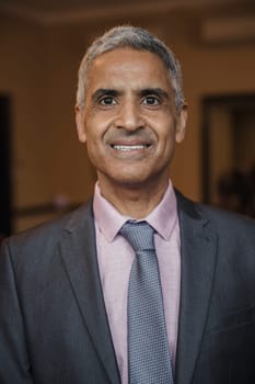Front view of a mature businessman giving a smile for the camera.