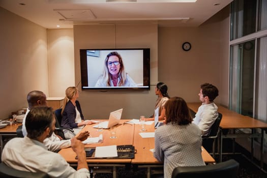 Having a business meeting with a video call late after work. Working late in the office.