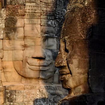 Stone face at the Bayon Temple the Tempel Ruins of Angkor Thom in the Temple City of Angkor near the City of Siem Reap in the west of Cambodia.  Cambodia, Siem Reap, April 2014