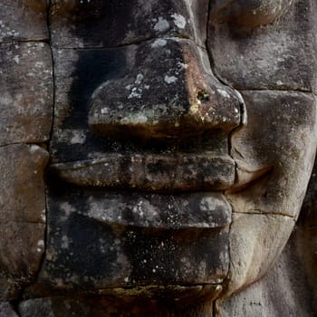 Stone face at the Bayon Temple the Tempel Ruins of Angkor Thom in the Temple City of Angkor near the City of Siem Reap in the west of Cambodia.  Cambodia, Siem Reap, April 2014
