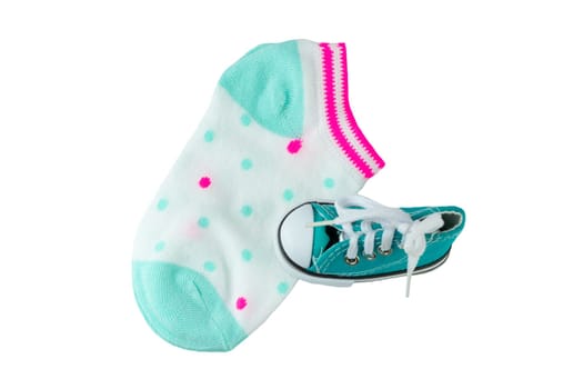 Baby goods. Closeup colorful baby socks and a baby shoe isolated on white background.