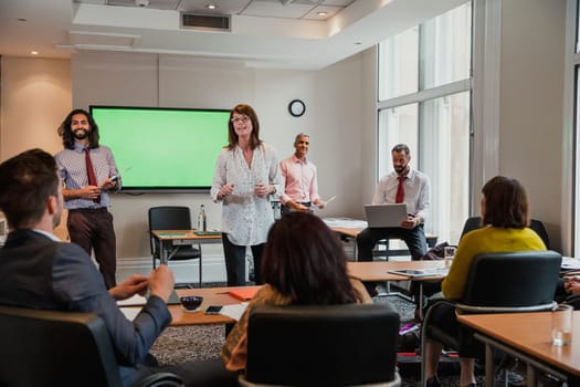 Group of business men and women giving a presentation to another small group of business men and women.