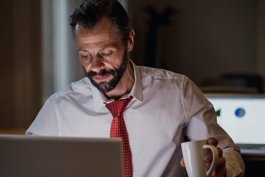 Front view of a businessman working late in the office to get his work finished before the deadline.