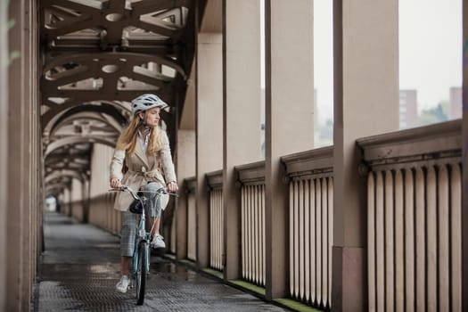 Front view of a businesswoman cycling over a bridge to get to her meeting.
