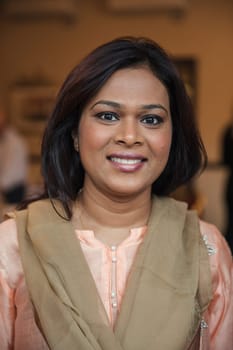 Front view of a mid-adult female looking at the camera for a headshot.