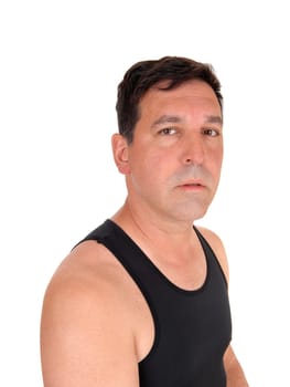 A serious looking man in a close up image looking into the camera.in a black undershirt, isolated for white background.