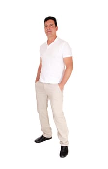 A tall handsome middle age man standing in a beige slacks and white.t-shirt with his hands in his pocket, isolated for white background.