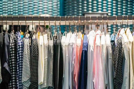 Solid and some pattern casual women's clothes hang on to green clothes line in the Asia - Korea fashion shop.
