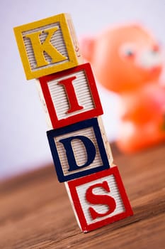 Colorful children toys on wooden background
