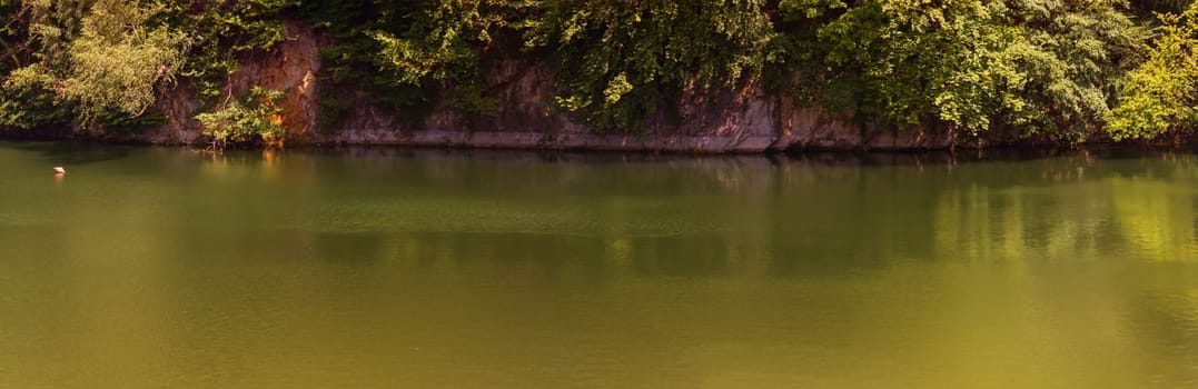 Lake with banks on the site of a former quarry for the extraction of limestone