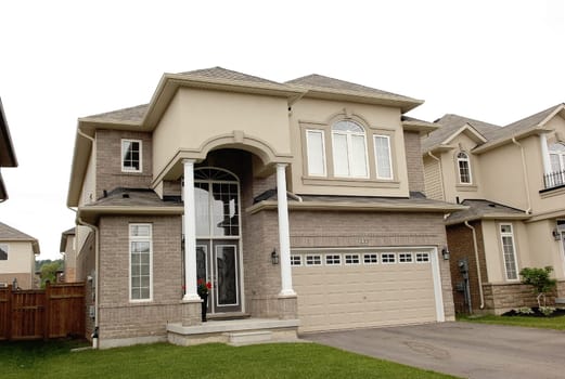 A new big two story house in a subdivision in Hamilton, Canada, .with a two car garage.