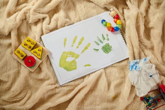 A vibrant depiction of children's handprint artwork, embodying creativity and family time on a soft surface, with colorful toys adding a playful atmosphere.