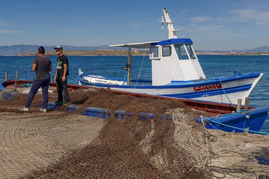 Carloforte, Island of San Pietro, Italy - 08 May 2014: "Mattanza"" is an ancient fishing technique based on nets. In Sardinia (southern Italy) there were many ""Tonnare"" to fish tuna in this way. The last active was the Tonnara of the island of San Pietro. In these scenes, fishing nets are prepared. the director of operations is called ""Rais""."