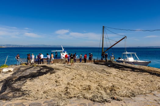 Carloforte, Island of San Pietro, Italy - 08 May 2014: "Mattanza"" is an ancient fishing technique based on nets. In Sardinia (southern Italy) there were many ""Tonnare"" to fish tuna in this way. The last active was the Tonnara of the island of San Pietro. In these scenes, fishing nets are prepared. the director of operations is called ""Rais""."