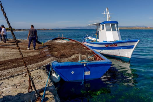Carloforte, Island of San Pietro, Italy - 08 May 2014: "Mattanza"" is an ancient fishing technique based on nets. In Sardinia (southern Italy) there were many ""Tonnare"" to fish tuna in this way. The last active was the Tonnara of the island of San Pietro. In these scenes, fishing nets are prepared. the director of operations is called ""Rais""."