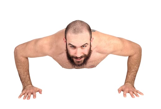 A young handsome man without a shirt doing push ups on the floor.in the studio, isolated for white background.